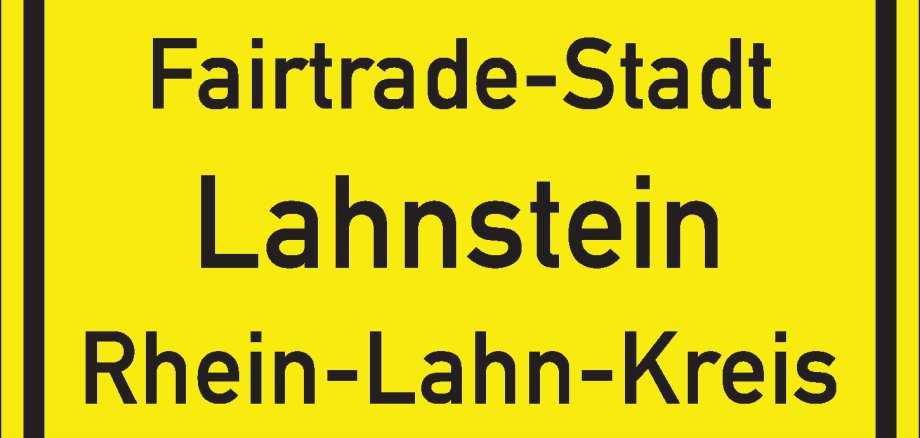 Fairtrade-Stadt Lahnstein Gelbes Ortsschild mit schwarzem Rand und schwarzer Schrift. Auf dem Schild steht in der oberen Zeile "Fairtrade-Stadt Lahnstein" und in der Zeile darunter "Rhein-Lahn-Kreis". Die Gestaltung orientiert sich an einem klassischen deutschen Ortseingangsschild.