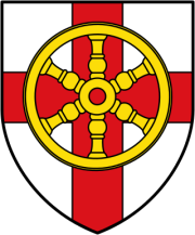 Wappen mit weißem Hintergrund und rotem Kreuz. In der Mitte befindet sich ein goldenes sechsspeichiges Rad mit roter Nabe, das das Kreuz überlagert.