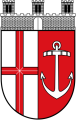 Geteiltes Wappen unter einer silbernen Mauerkrone mit drei Türmen. Die linke Schildhälfte zeigt ein silbernes Feld mit rotem Kreuz, die rechte ein rotes Feld mit einem silbernen Anker.